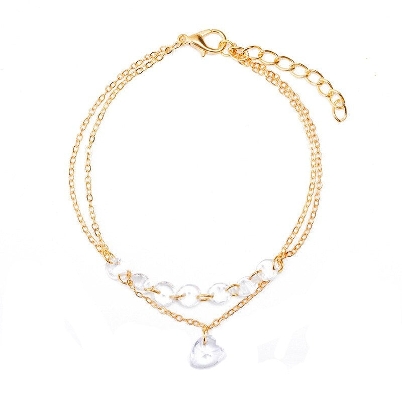 Bracelet doré chaine double strass en forme de coeur. Détails produit : Couleur or. Métal doré. Strass en forme de coeur.
